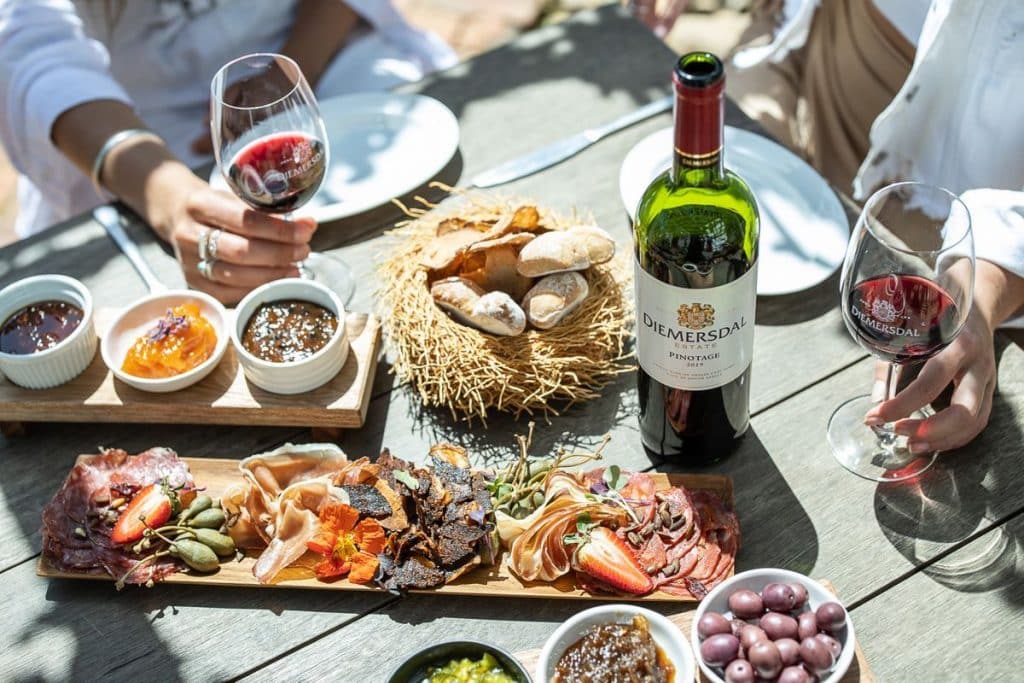 A wine and food pairing platter with cheese, charcuterie and red wine