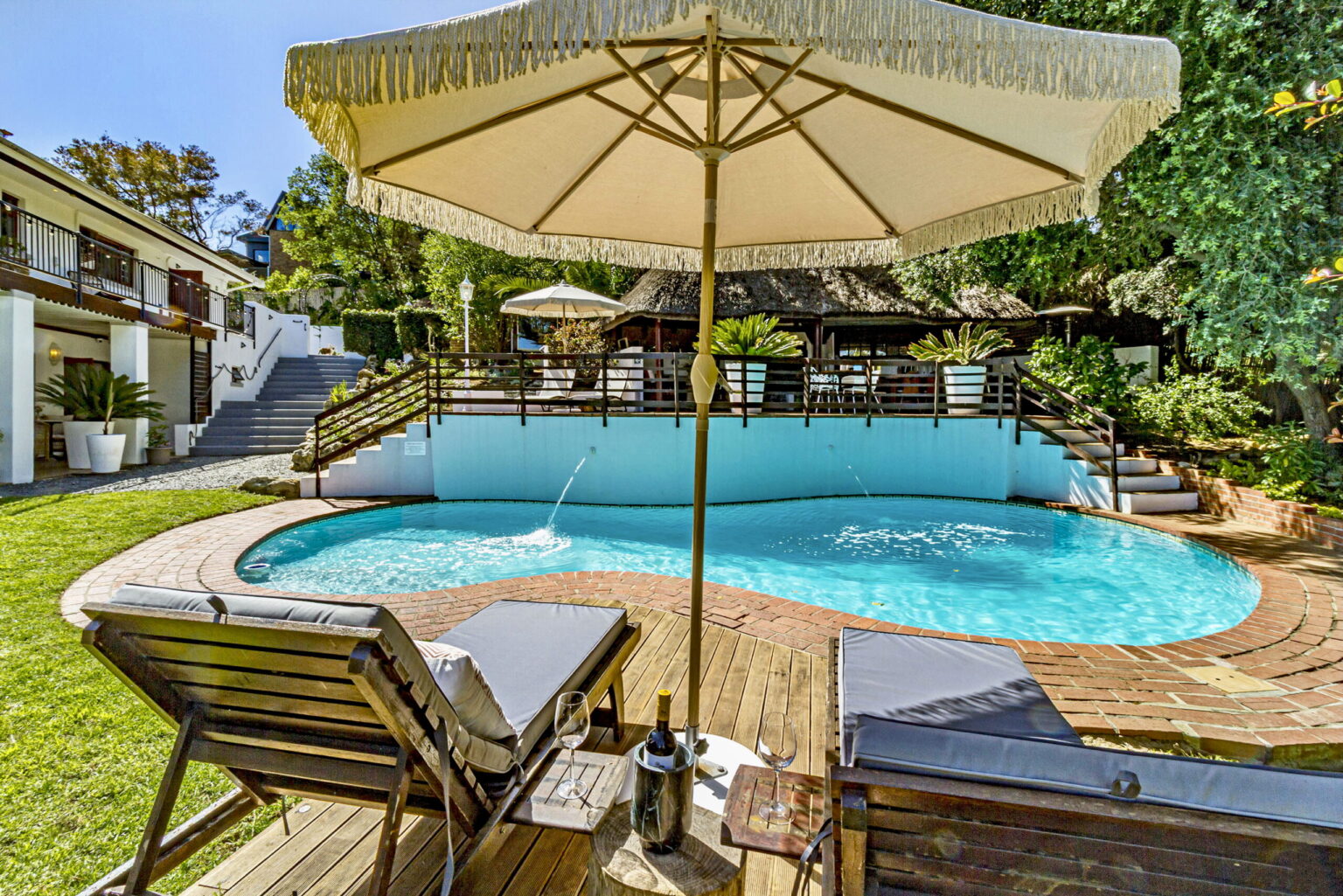 Sun loungers and a parasol beside the pool