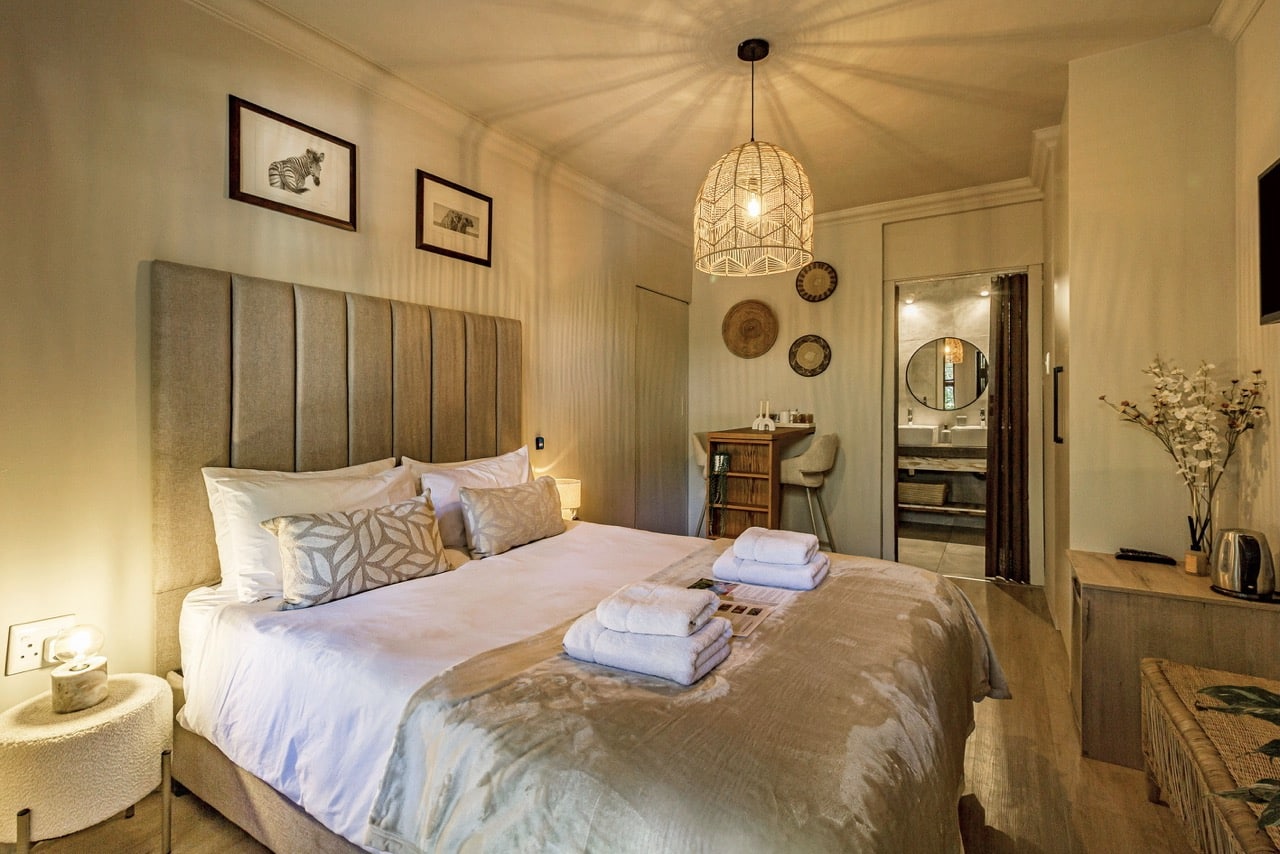 Garden Room 1: a bedroom with a queen bed and a padded headboard
