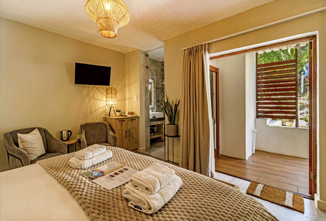 Pool Suite 1: the view from the bed through the open door onto the terrace