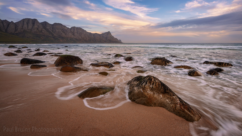Boulders and waves at Dappat se Gat on the Kogel Bay coast at sunset