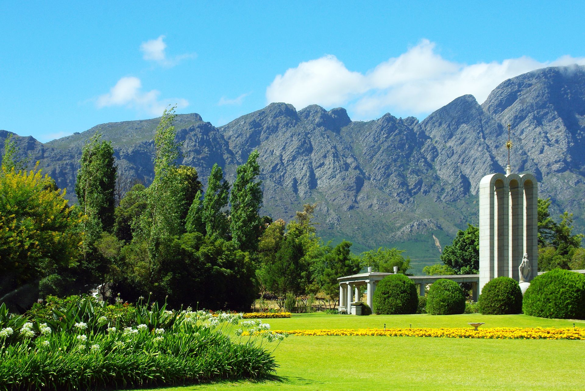 The Huguenot Monument at the end of Franschhoek's main road, with the mountains behind
